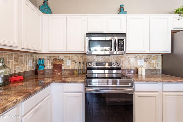 kitchen featuring appliances with stainless steel finishes, decorative backsplash, and white cabinets