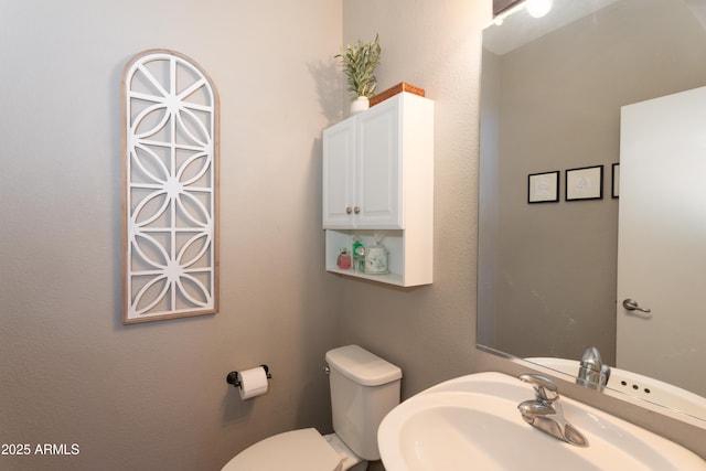 bathroom featuring a sink and toilet
