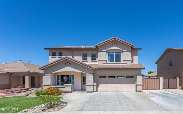 view of front of property featuring concrete driveway, stucco siding, a tiled roof, and an attached garage