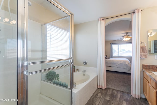 ensuite bathroom with ensuite bathroom, a ceiling fan, an enclosed shower, vanity, and wood finished floors