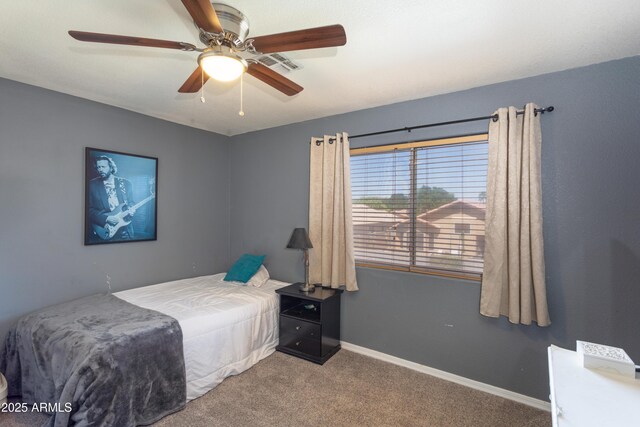carpeted bedroom with ceiling fan, baseboards, and visible vents