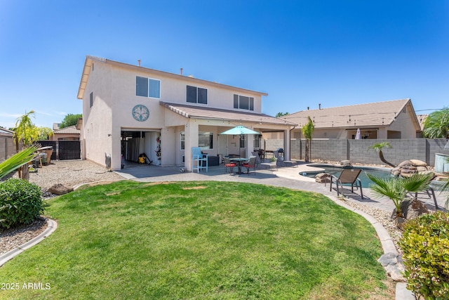 back of house featuring a yard, a fenced backyard, stucco siding, a patio area, and a fenced in pool