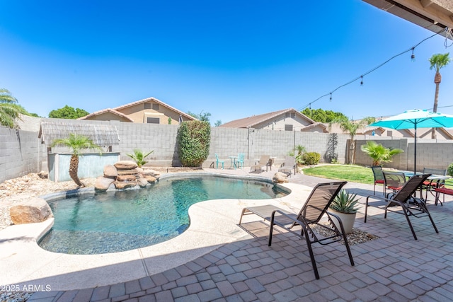 view of swimming pool with a patio, a fenced backyard, and a fenced in pool