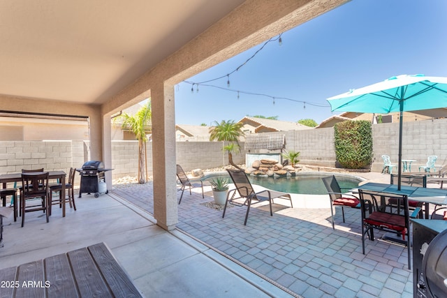view of patio with grilling area, outdoor dining space, and a fenced backyard