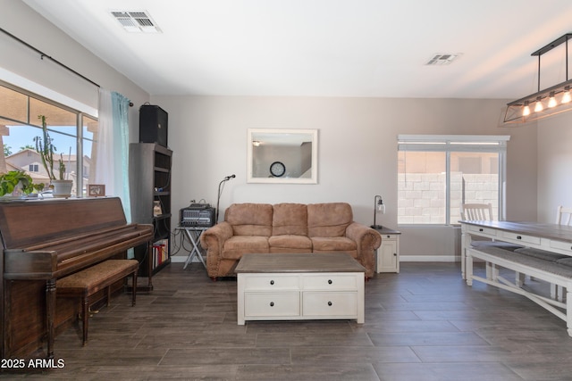living room featuring baseboards, dark wood-style floors, and visible vents