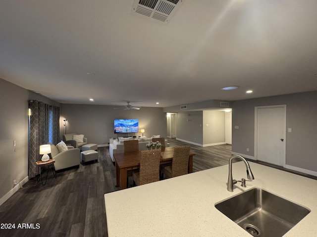 kitchen with dark hardwood / wood-style flooring, ceiling fan, and sink