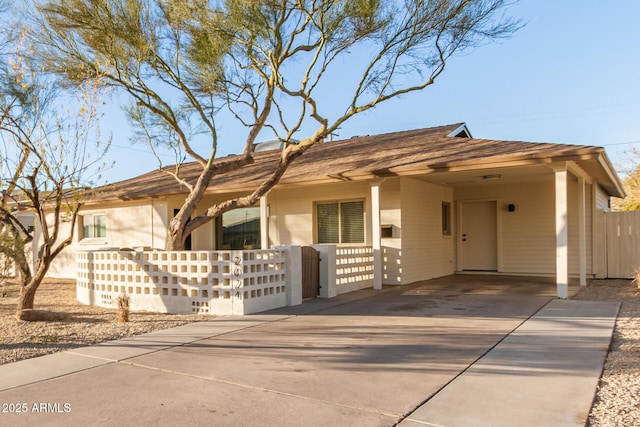 ranch-style house featuring a carport