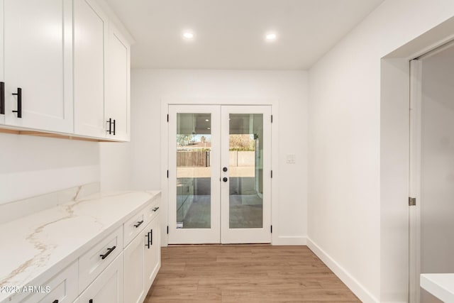 doorway to outside with light hardwood / wood-style floors and french doors