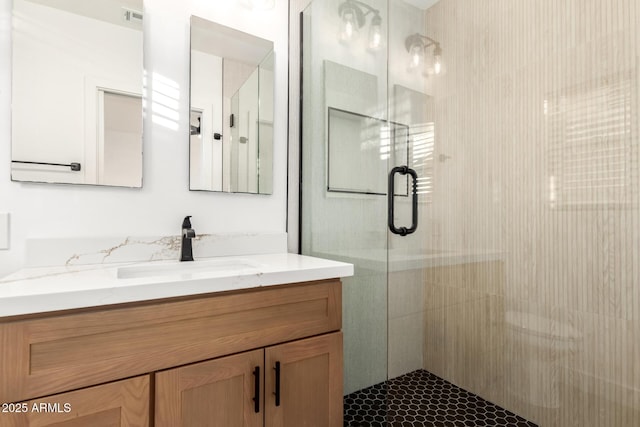 bathroom with an enclosed shower and vanity