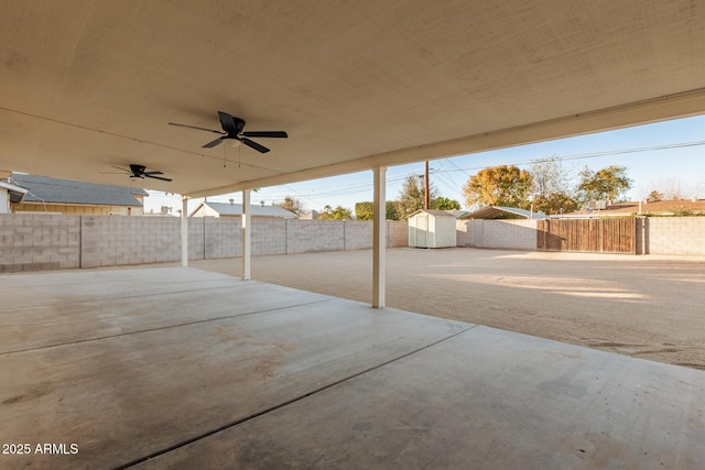 view of patio / terrace with a storage shed and ceiling fan