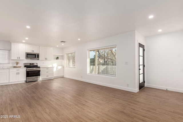 kitchen featuring light hardwood / wood-style floors, white cabinetry, and stainless steel appliances