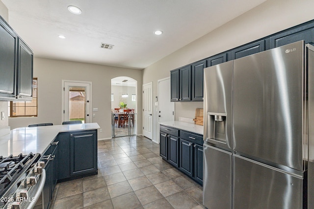 kitchen with stainless steel appliances and dark tile patterned floors