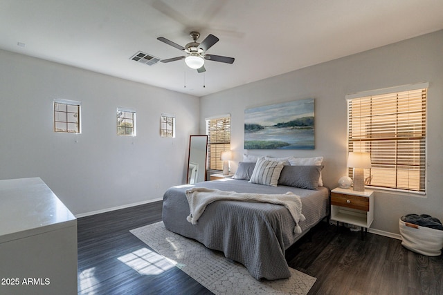 bedroom with ceiling fan and dark hardwood / wood-style flooring