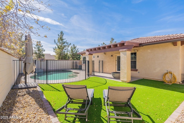 view of yard with a fenced in pool and a patio