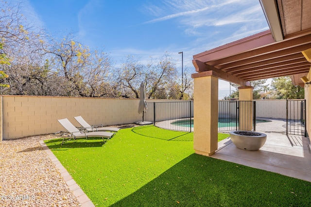 view of yard with a fenced in pool and a patio