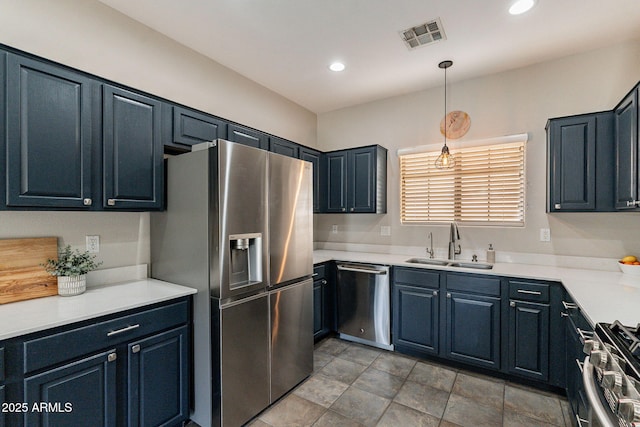 kitchen featuring stainless steel appliances, sink, and hanging light fixtures