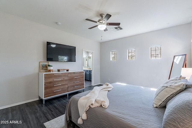 bedroom with ceiling fan, connected bathroom, and dark hardwood / wood-style flooring