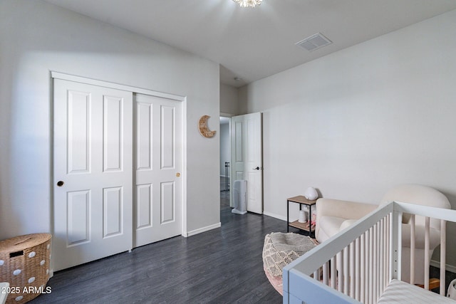 bedroom featuring dark wood-type flooring and a closet