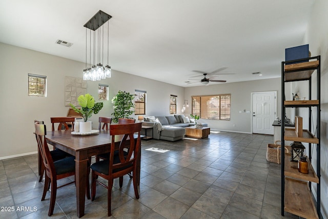 tiled dining area with ceiling fan