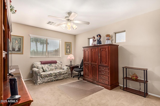 sitting room featuring plenty of natural light, light carpet, and ceiling fan