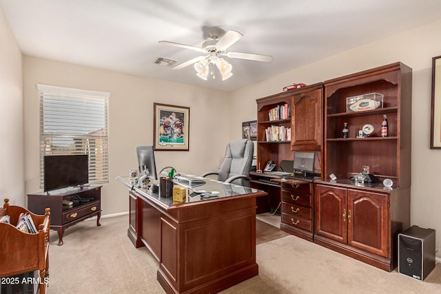 office space with light carpet and ceiling fan