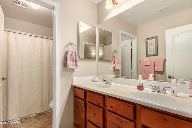 bathroom with vanity, toilet, and a shower with shower curtain