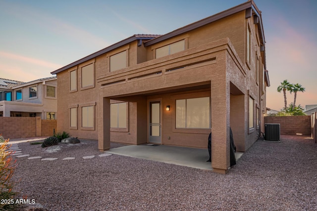 view of front of house with a patio and central AC unit