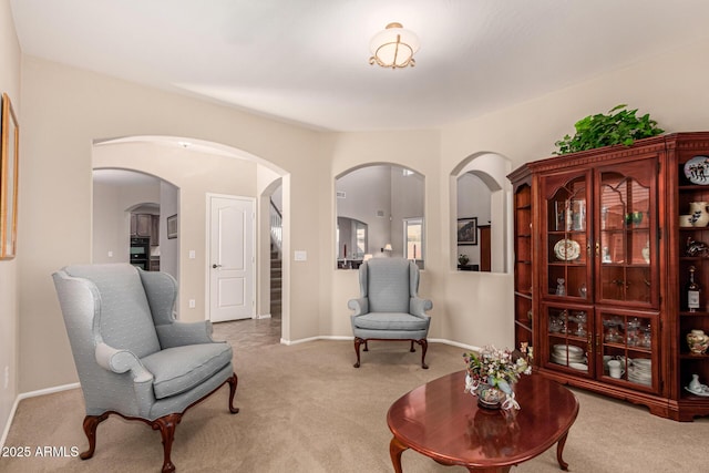 sitting room featuring light colored carpet