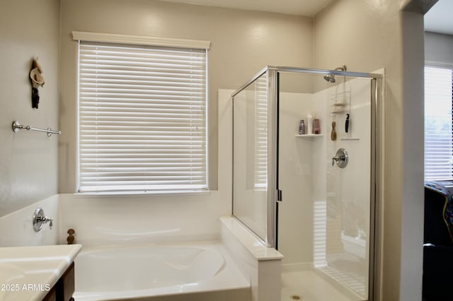 bathroom featuring vanity and independent shower and bath