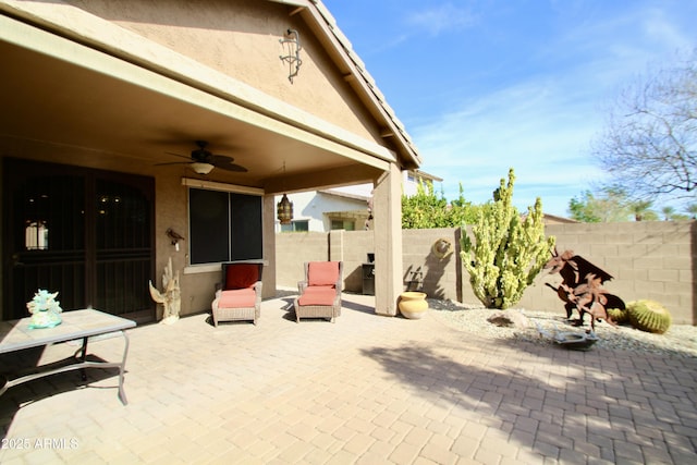 view of patio featuring ceiling fan