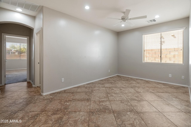unfurnished room featuring visible vents, arched walkways, ceiling fan, and recessed lighting