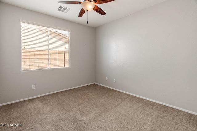 spare room featuring baseboards, visible vents, a ceiling fan, and carpet