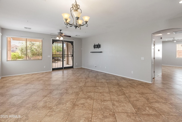 empty room featuring arched walkways, visible vents, baseboards, and ceiling fan with notable chandelier
