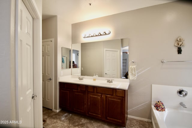 bathroom with vanity and a tub