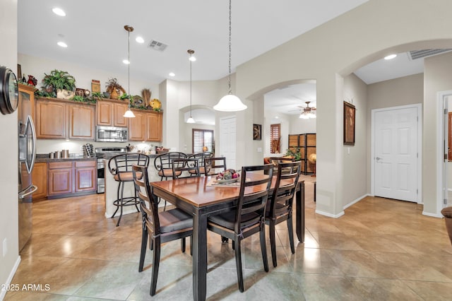 3214 N 138th Dr, Avondale, AZ 85392 - dining room featuring arched walkways, a ceiling fan, baseboards, light tile patterned floors, and recessed lighting