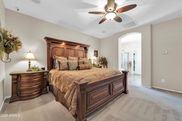 3214 N 138th Dr, Avondale, AZ 85392 - bedroom featuring arched walkways, light colored carpet, baseboards, and ceiling fan