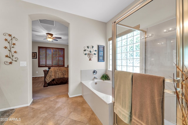 3214 N 138th Dr, Avondale, AZ 85392 - bathroom featuring a bath, a ceiling fan, a shower stall, baseboards, and tile patterned flooring