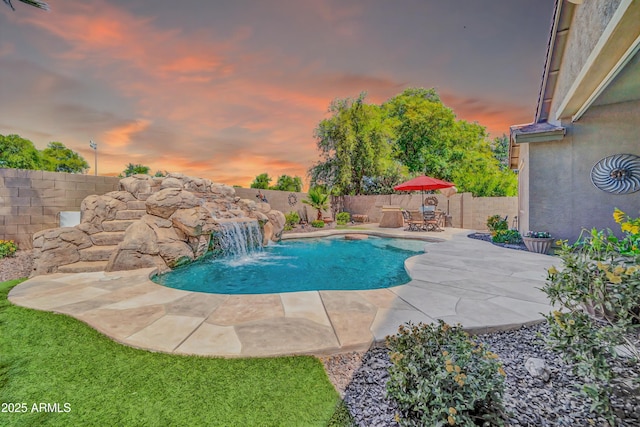 3214 N 138th Dr, Avondale, AZ 85392 - pool at dusk featuring a fenced backyard and a patio area