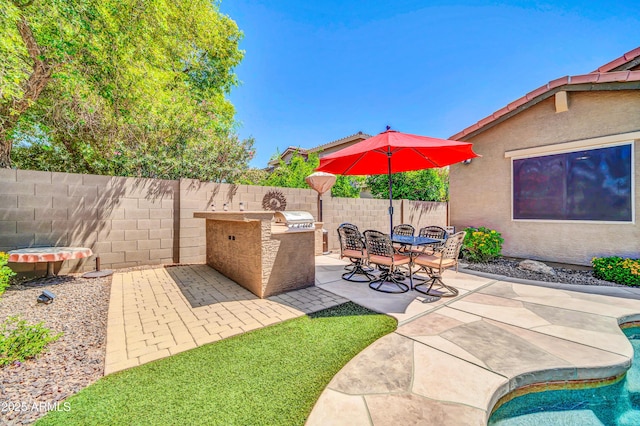 3214 N 138th Dr, Avondale, AZ 85392 - fenced backyard with area for grilling, a patio, an outdoor pool, and outdoor dining area