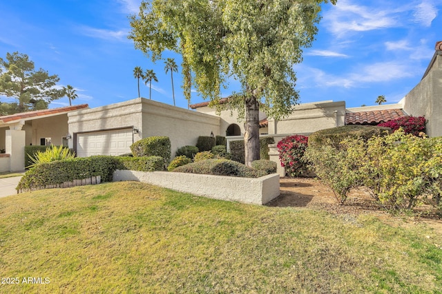 mediterranean / spanish house with a garage and a front yard