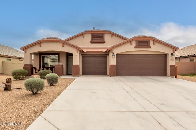 5569 E Athena Rd, Florence, AZ 85132 - mediterranean / spanish-style home featuring stucco siding, driveway, a garage, fence, and a tile roof