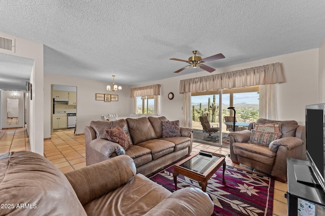 637 Chaparral Rd, Wickenburg, AZ 85390 - living room featuring visible vents, a textured ceiling, ceiling fan with notable chandelier, and light tile patterned floors
