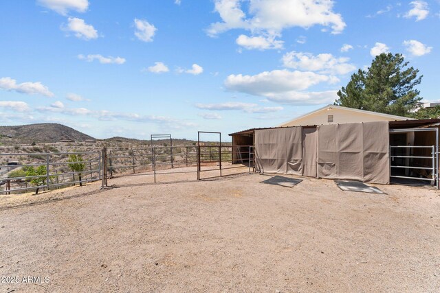 637 Chaparral Rd, Wickenburg, AZ 85390 - view of yard featuring an outdoor structure, an exterior structure, and a mountain view