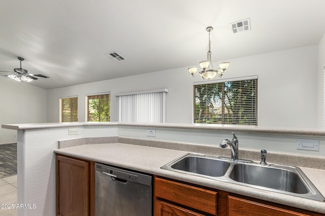 kitchen with pendant lighting, ceiling fan with notable chandelier, black dishwasher, and sink