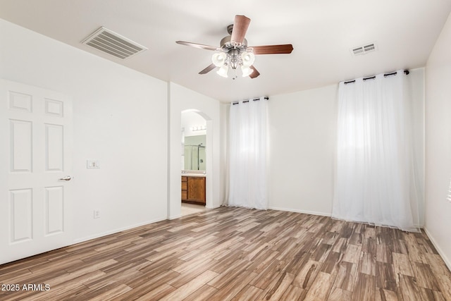 unfurnished room featuring ceiling fan and light hardwood / wood-style flooring