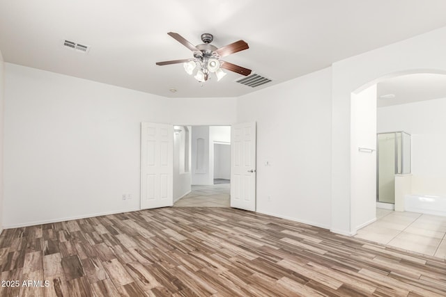 empty room featuring ceiling fan and light hardwood / wood-style floors