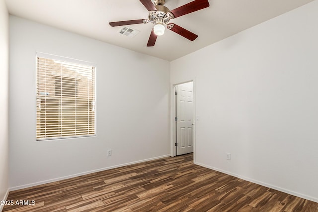 empty room with dark hardwood / wood-style flooring and ceiling fan