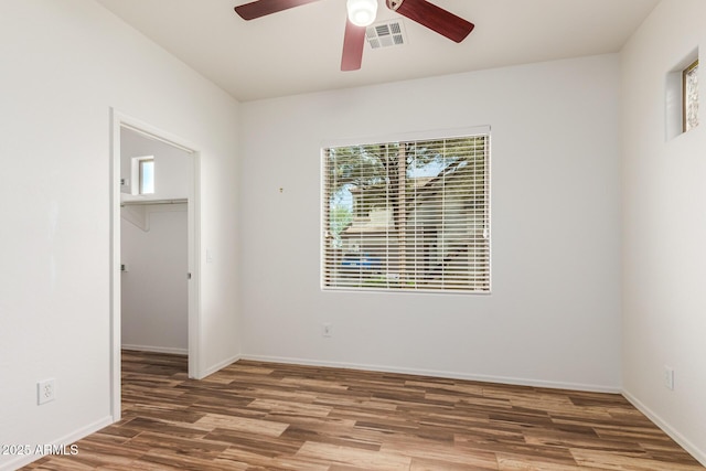 unfurnished room featuring hardwood / wood-style floors and ceiling fan