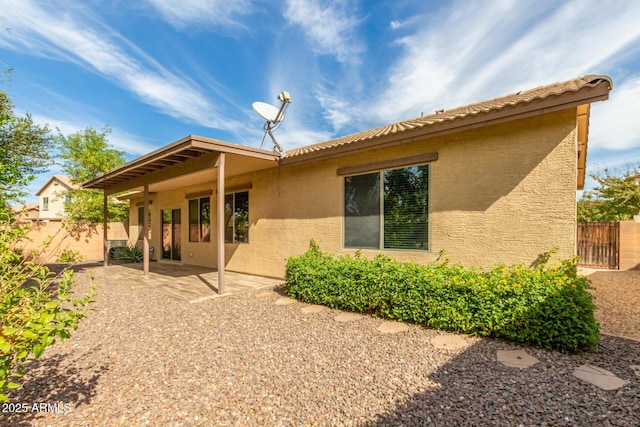 back of property with a patio