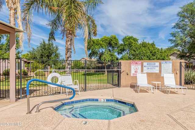 view of pool with a hot tub